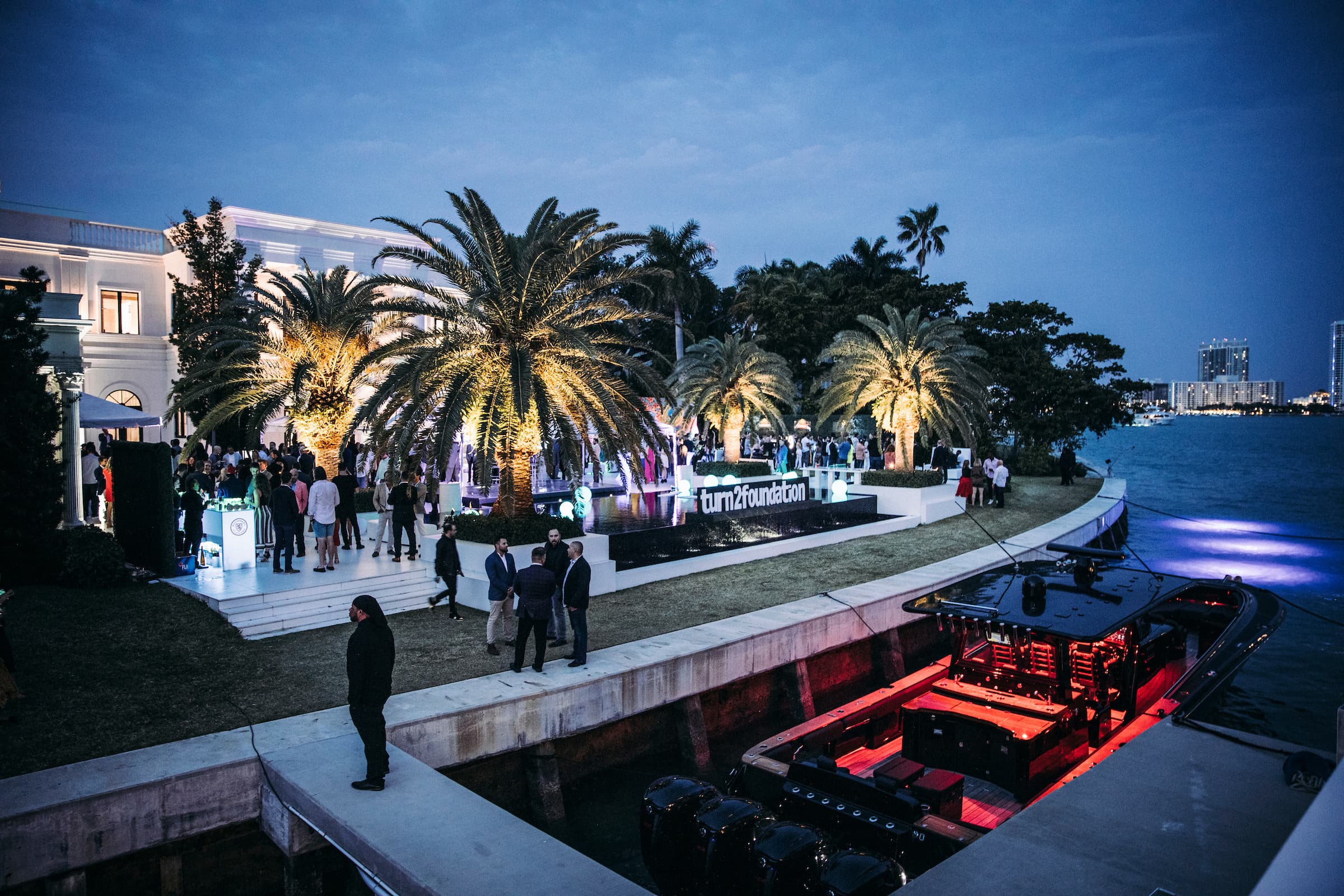 Twilight gala at a waterfront mansion